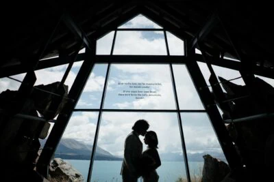 Kyoto Tokyo Japan Elopement Wedding Photographer, Planner & Videographer | A queenstown wedding photographer captures the magical moment of a bride and groom standing in front of a window in a church.