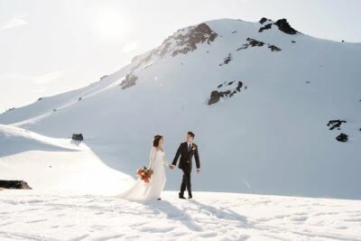 Kyoto Tokyo Japan Elopement Wedding Photographer, Planner & Videographer | Ayaka Morita's portfolio featuring a bride and groom standing on top of a snow covered mountain.