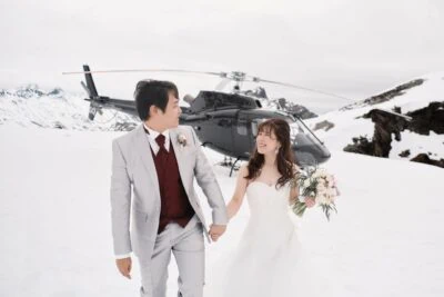 Kyoto Tokyo Japan Elopement Wedding Photographer, Planner & Videographer | Ayaka Morita's portfolio featuring a bride and groom standing next to a helicopter in the snow.