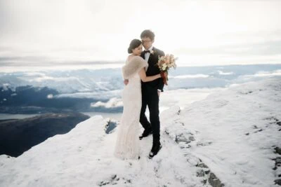 Kyoto Tokyo Japan Elopement Wedding Photographer, Planner & Videographer | Ayaka Morita, a bride and groom, standing on top of a snow covered mountain.