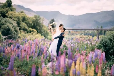 Kyoto Tokyo Japan Elopement Wedding Photographer, Planner & Videographer | A bride and groom embracing in a field of purple flowers. This stunning moment captured by Ayaka Morita showcases their love and the beauty of nature.