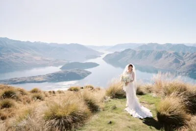 Queenstown New Zealand Elopement Wedding Photographer - A bride standing on top of Coromandel Peak overlooking Lake Wanaka during a Heli-Wedding ceremony.
