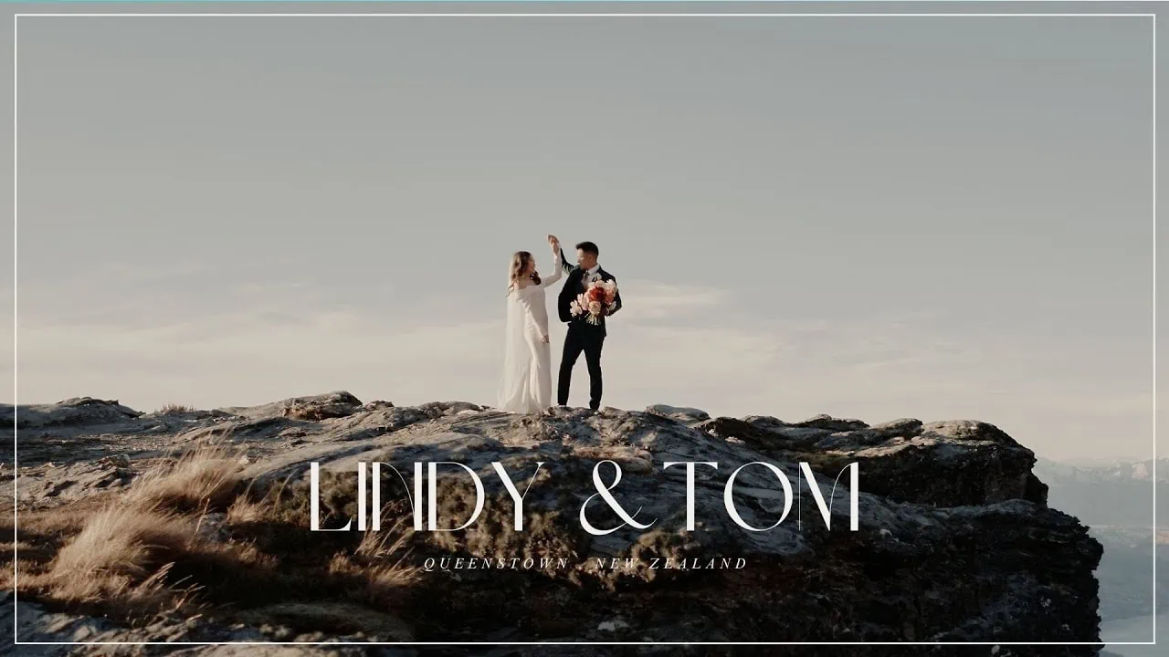 Queenstown New Zealand Elopement Wedding Photographer - A couple standing on top of a mountain in Queenstown, in a Lindy & Tom elopement wedding video.