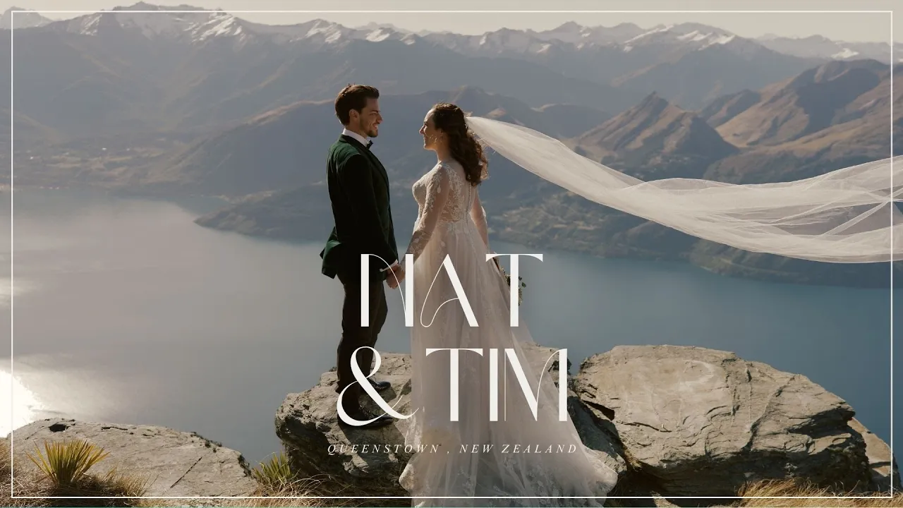 Queenstown New Zealand Elopement Wedding Photographer - Ayaka, a Queenstown Wedding Photographer, captures a breathtaking moment of a bride and groom standing on top of a mountain.