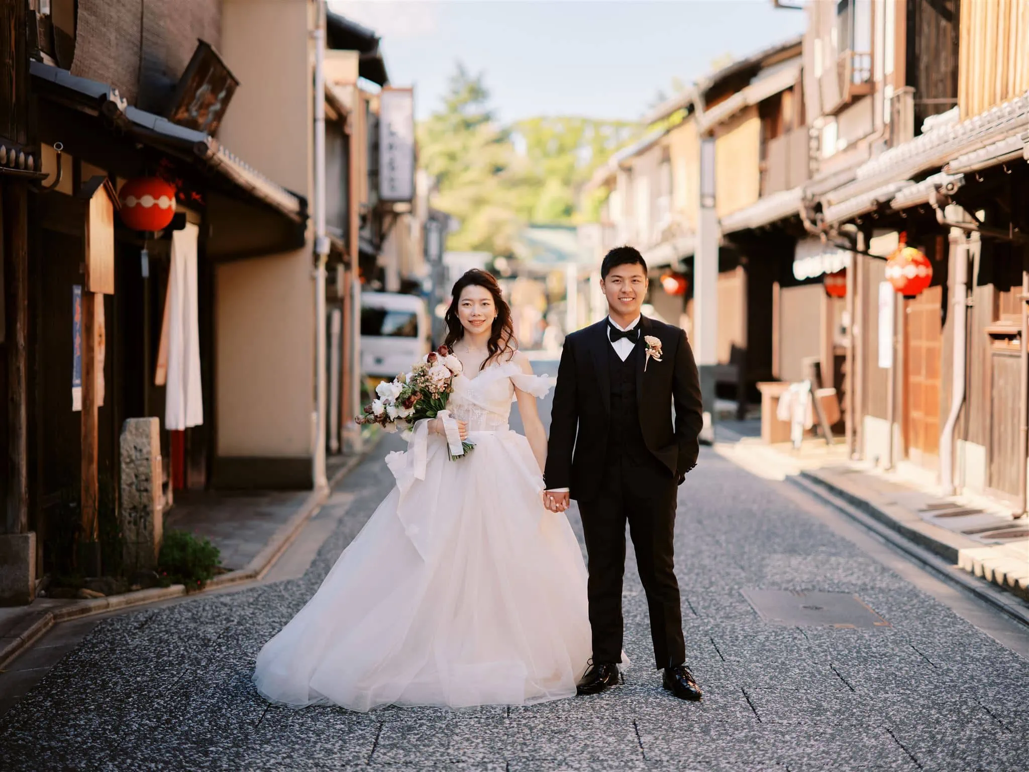 Kyoto Tokyo Japan Elopement Wedding Photographer, Planner & Videographer | A newlywed couple standing in a narrow alleyway, showcasing the latest wedding trends.