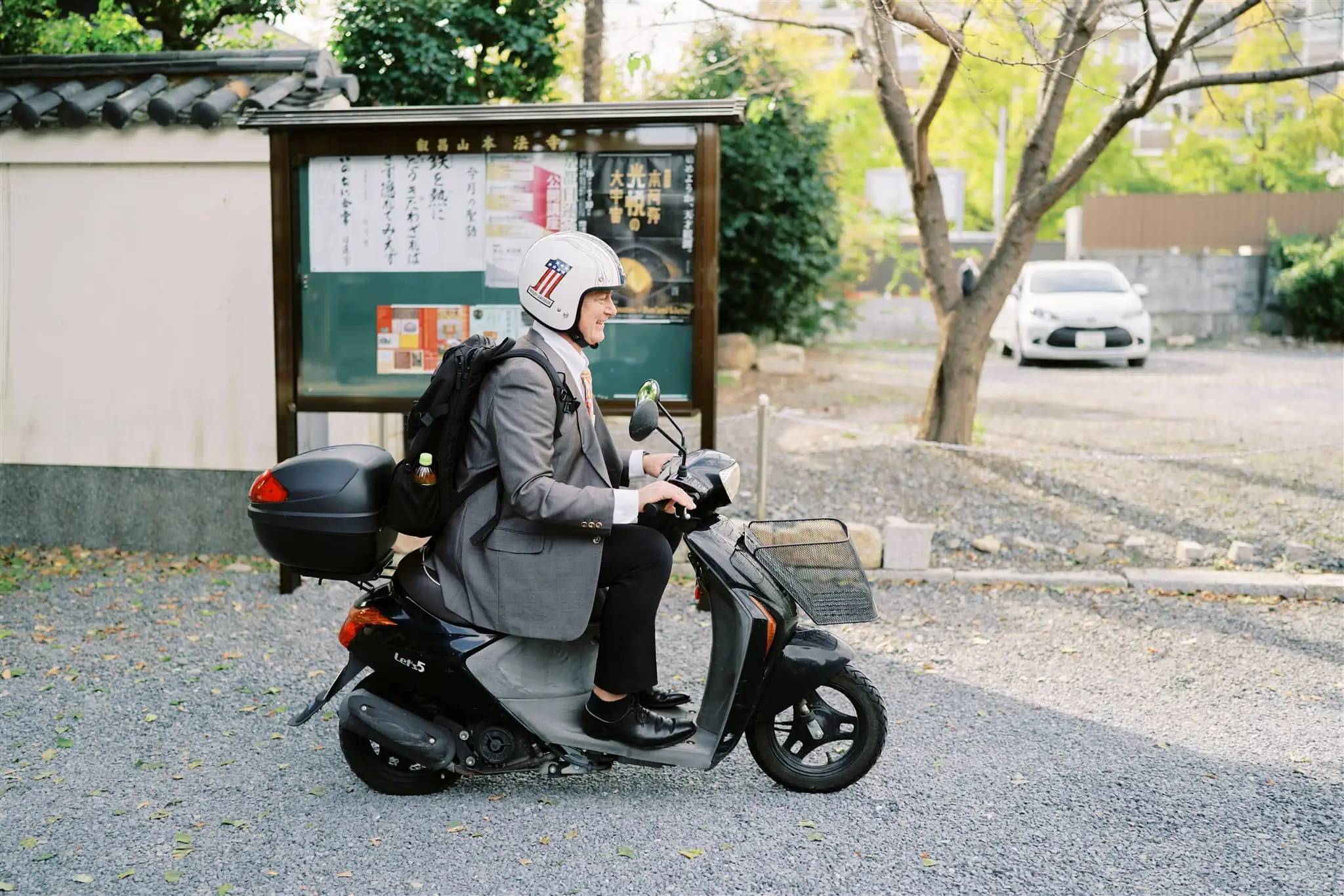 Kyoto Tokyo Japan Elopement Wedding Photographer, Planner & Videographer | A person on a scooter exploring the streets of Japan.