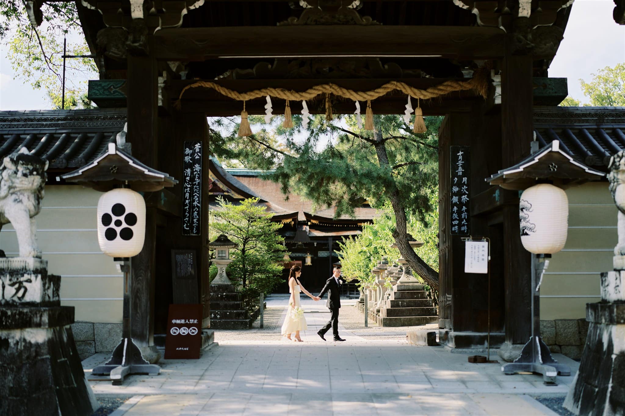 Kyoto Tokyo Japan Elopement Wedding Photographer, Planner & Videographer | A Japan elopement with a bride and groom standing in front of a Japanese temple.