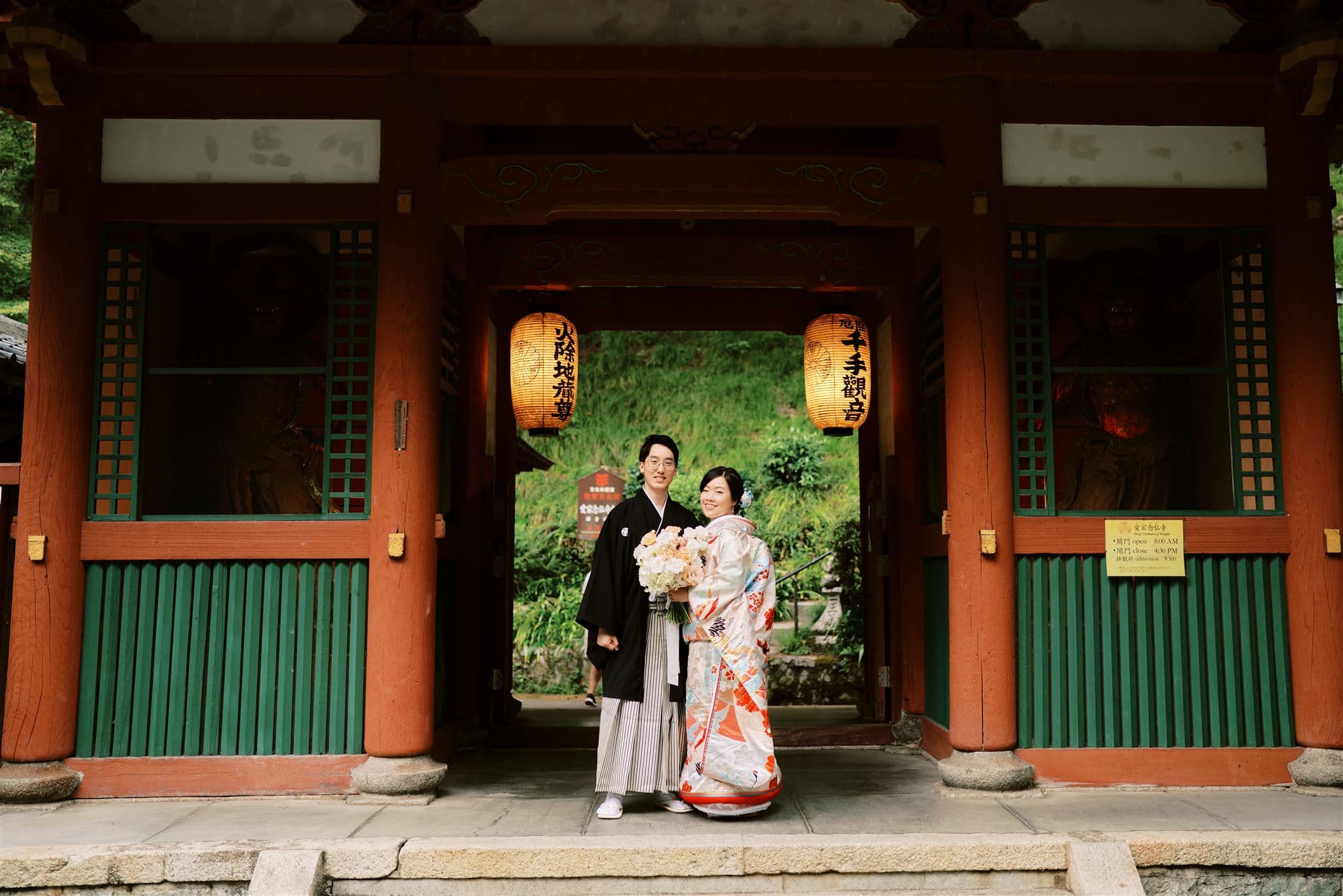 Japan Elopement Wedding Photographer, Planner & Videographer | A couple in kimono standing in front of a shrine, planning their elopement wedding in Japan.