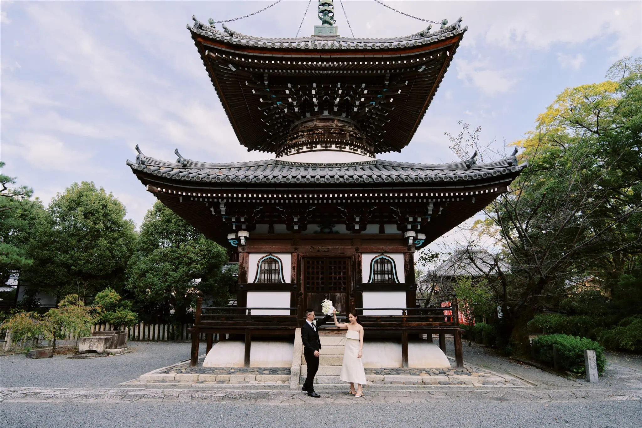 Kyoto Tokyo Japan Elopement Wedding Photographer, Planner & Videographer | A Japan elopement, with a bride and groom standing in front of a pagoda.