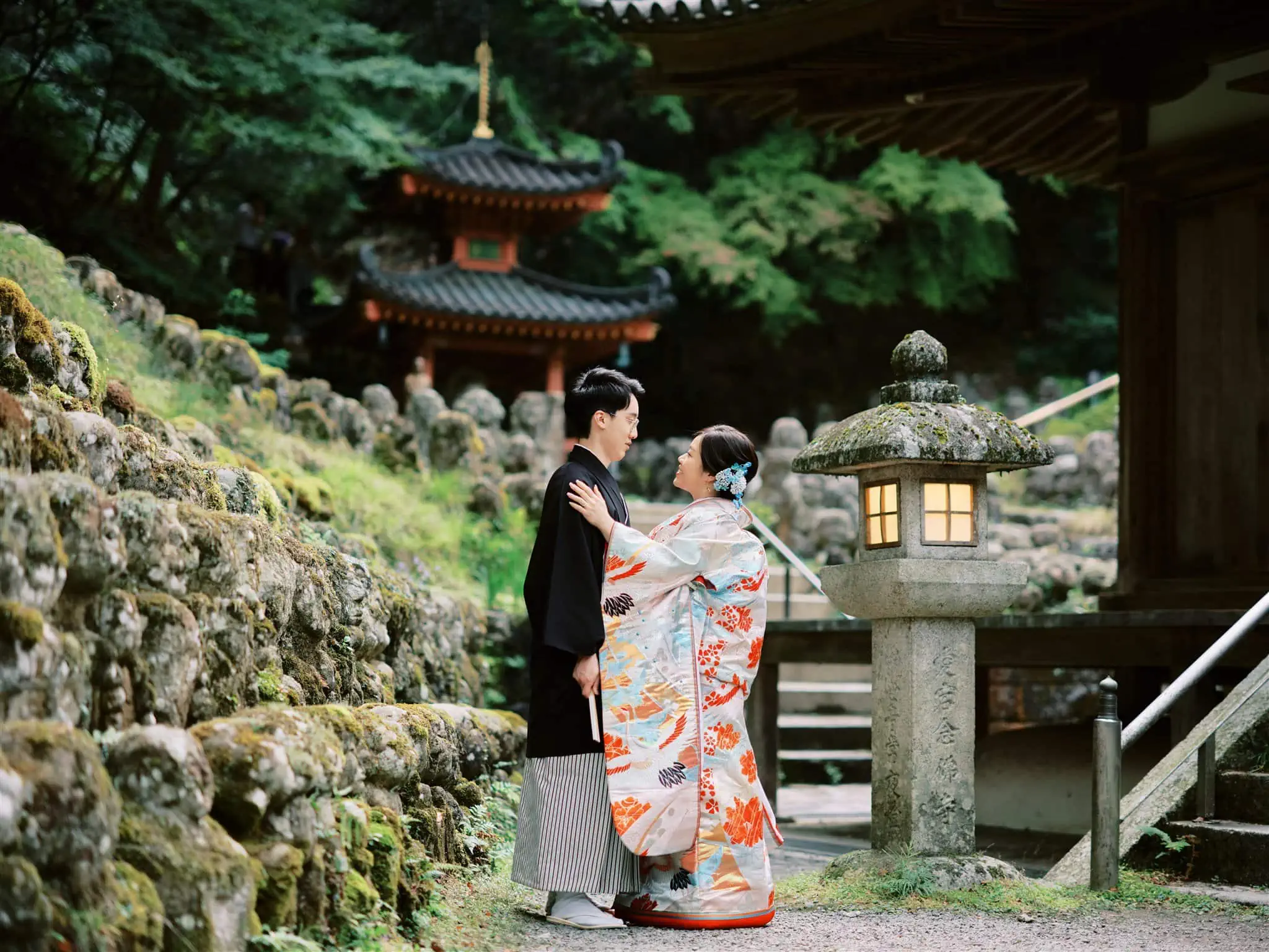 Kyoto Tokyo Japan Elopement Wedding Photographer, Planner & Videographer | An elopement photographer captures a Japanese couple in traditional kimono posing in front of a temple.