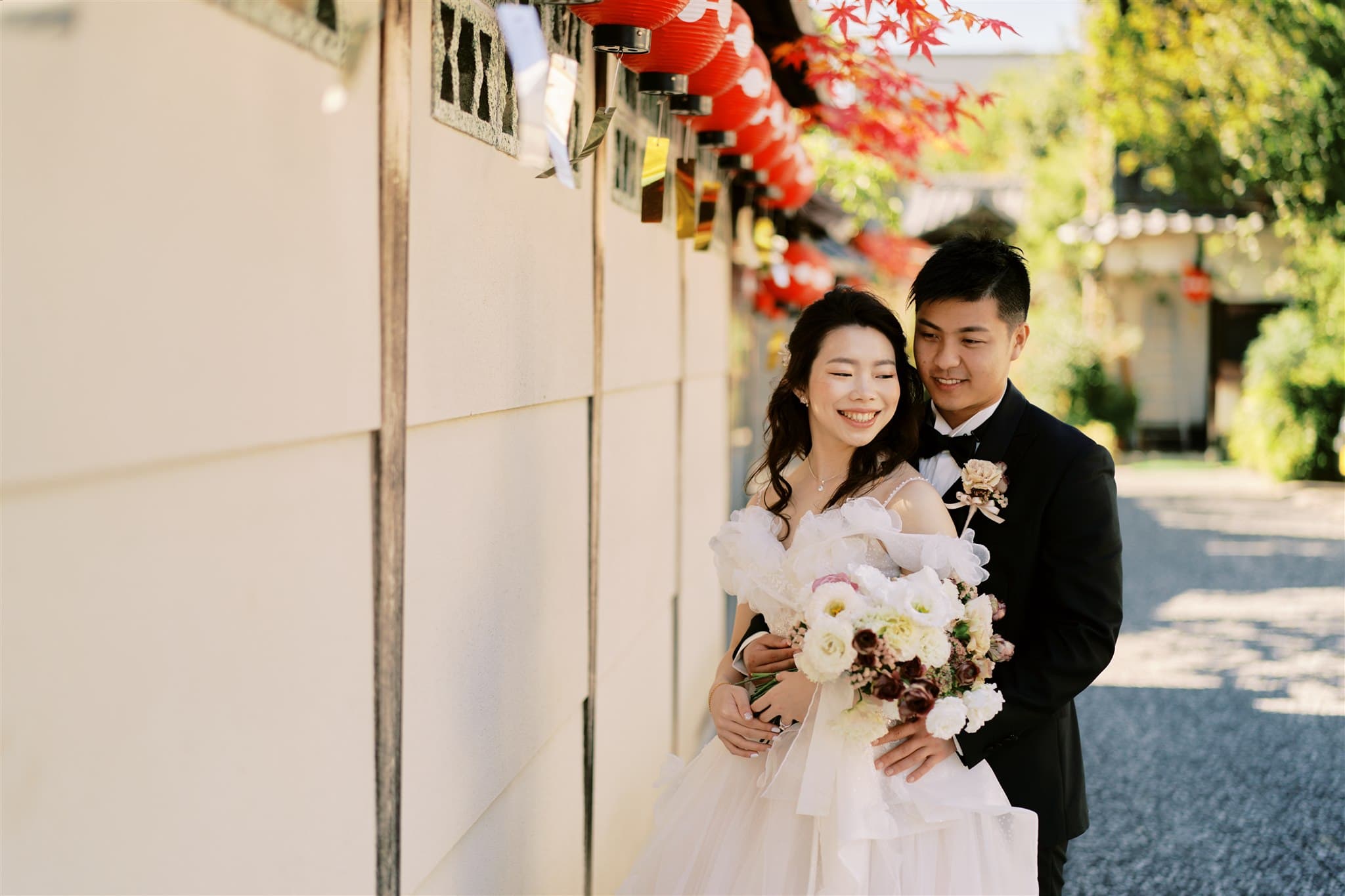 Kyoto Tokyo Japan Elopement Wedding Photographer, Planner & Videographer | A Japan elopement photographer captures a bride and groom posing for a photo in front of a wall.