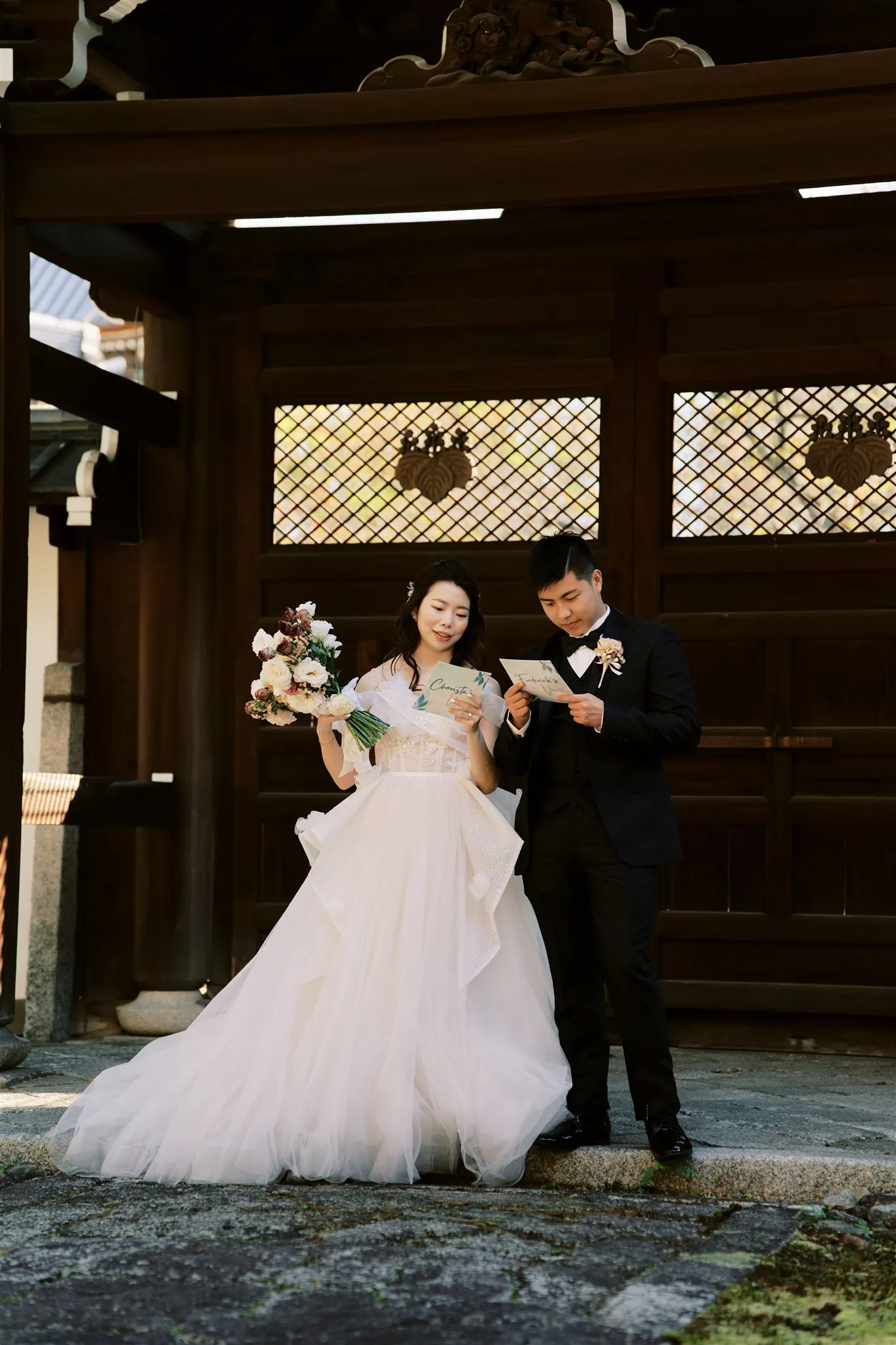 Kyoto Tokyo Japan Elopement Wedding Photographer, Planner & Videographer | A Japan elopement photographer captures a bride and groom standing in front of a temple.