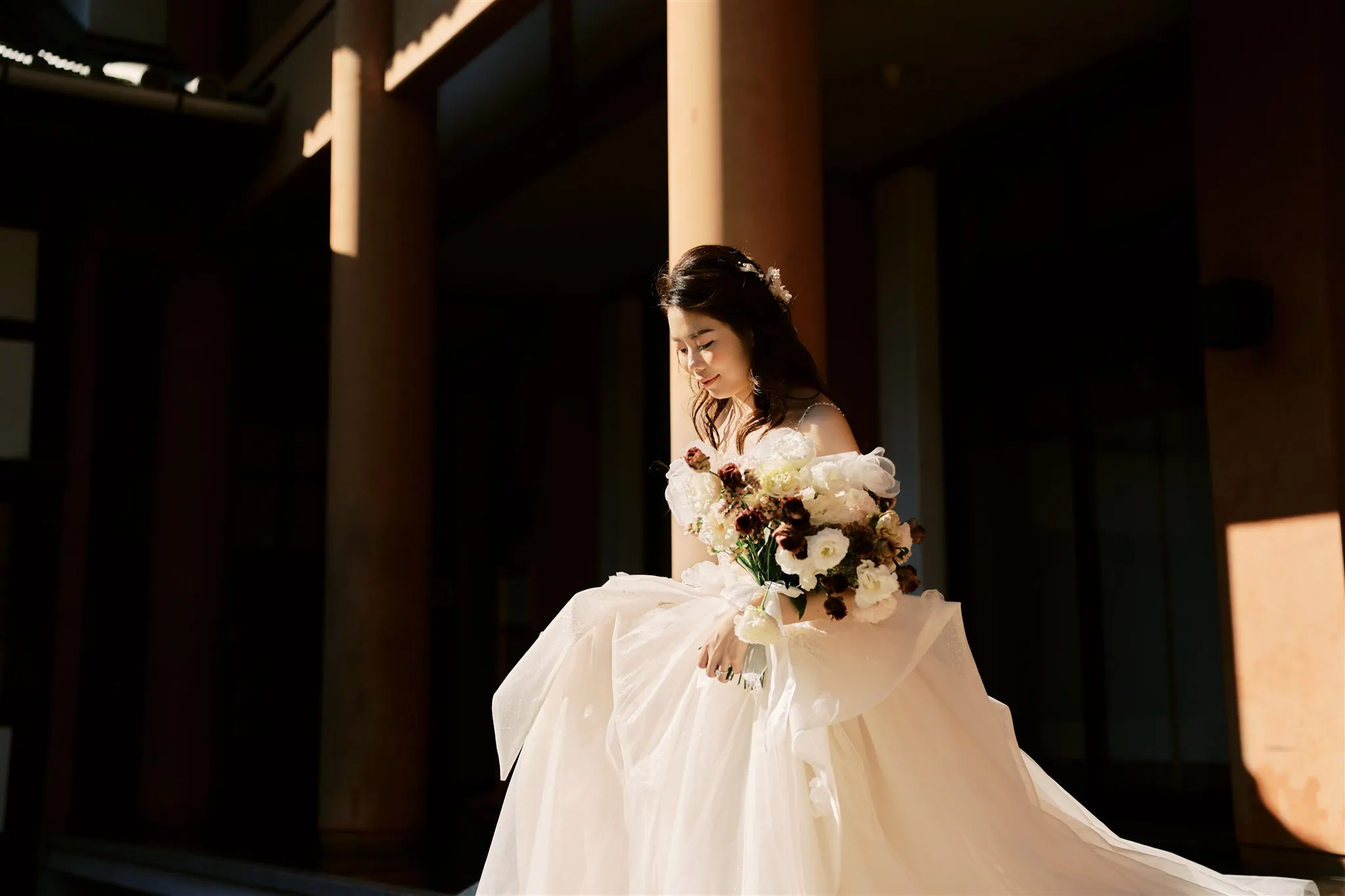 Kyoto Tokyo Japan Elopement Wedding Photographer, Planner & Videographer | A Japan bride in a wedding dress standing in front of pillars, captured beautifully by an elopement photographer.
