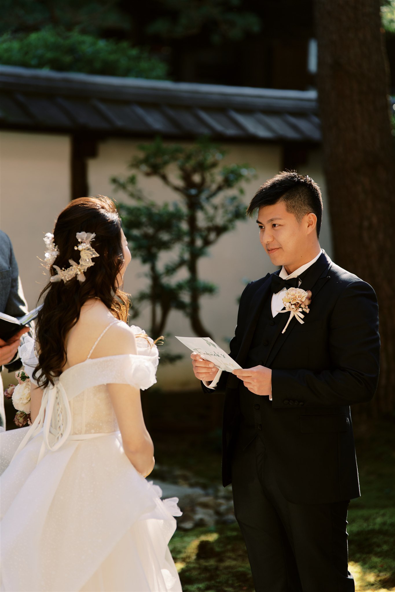 Kyoto Tokyo Japan Elopement Wedding Photographer, Planner & Videographer | A Japan elopement photographer captures the special moment as a bride and groom exchange vows in a serene garden.