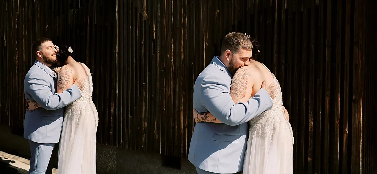 Kyoto Tokyo Japan Elopement Wedding Photographer, Planner & Videographer | A bride and groom hugging in front of a wooden wall, captured by a talented elopement photographer.