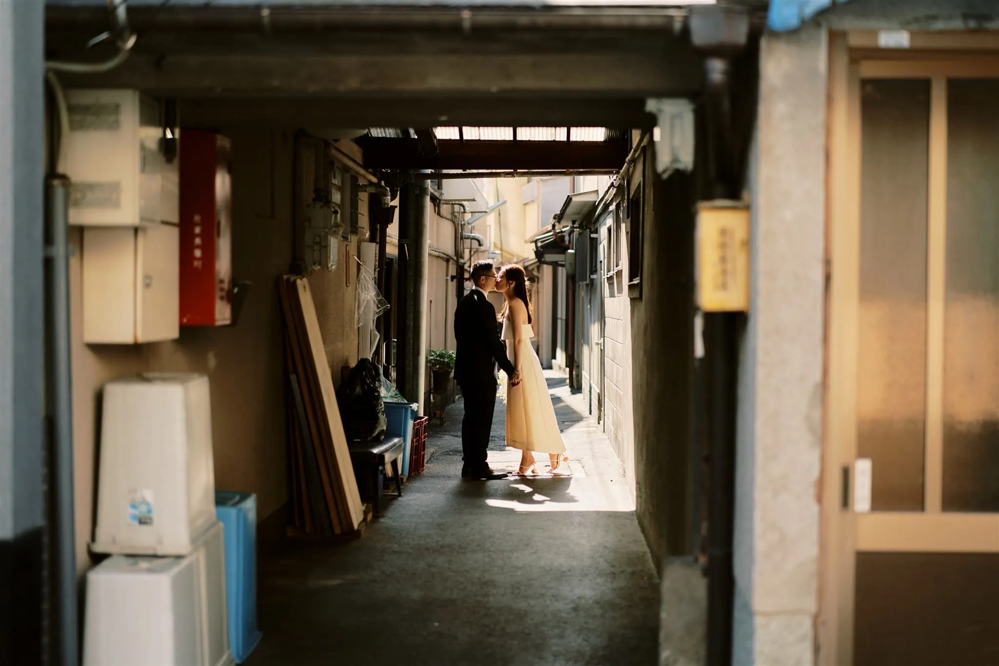 Kyoto Tokyo Japan Elopement Wedding Photographer, Planner & Videographer | A Japan elopement featuring a bride and groom passionately kissing in an alleyway.