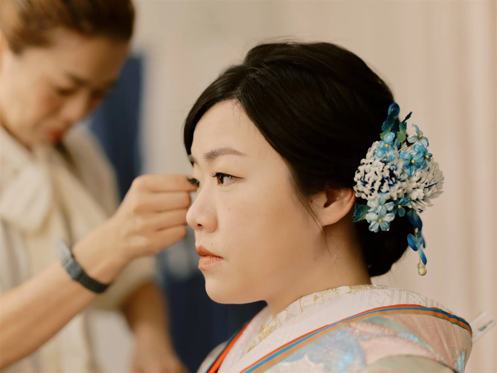 Kyoto Tokyo Japan Elopement Wedding Photographer, Planner & Videographer | A woman is getting her hair done in a Japanese kimono for her elopement photographs.