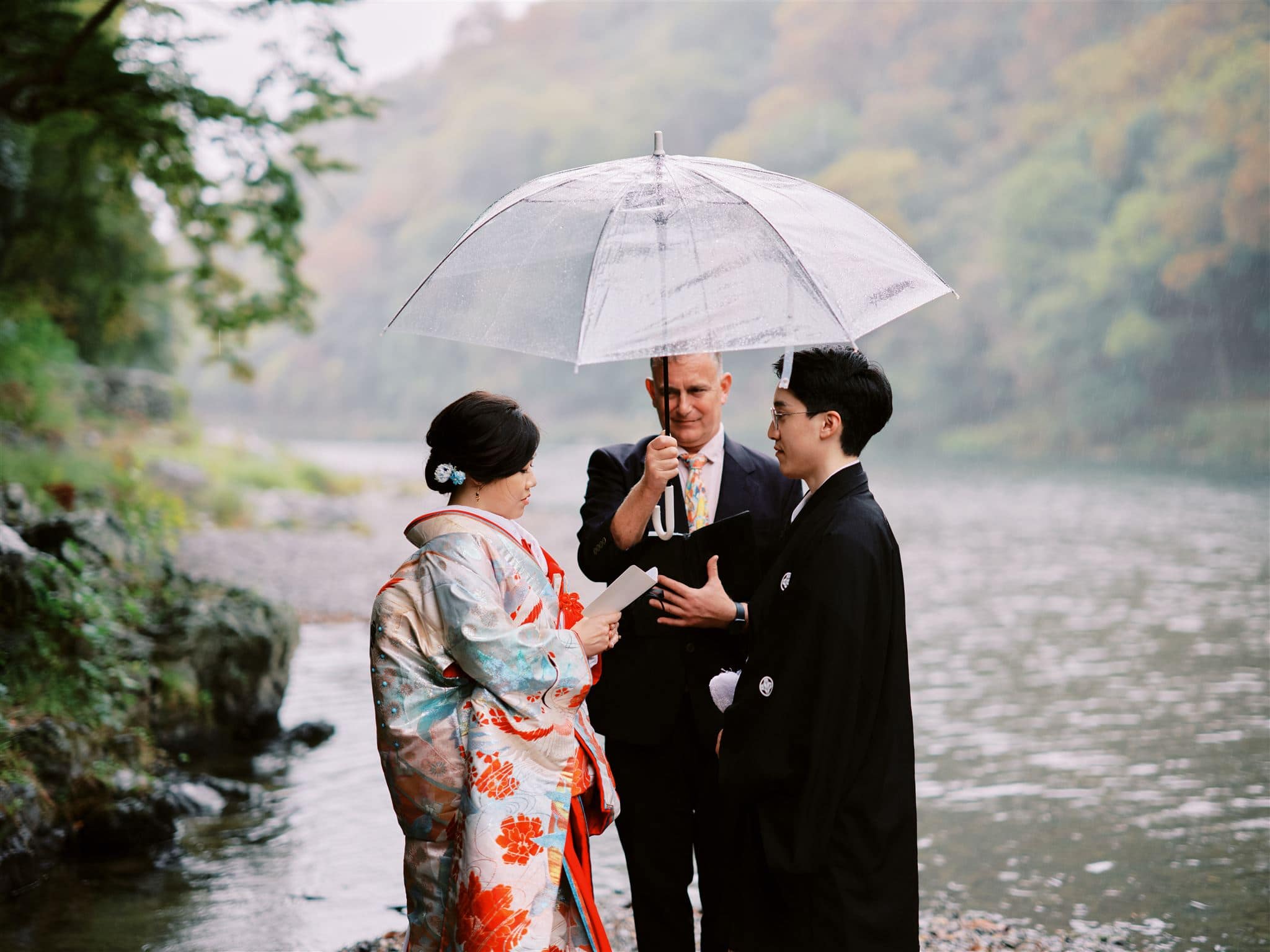 Japan Elopement Wedding Photographer, Planner & Videographer | A group of people standing by a river, planning their elopement.
