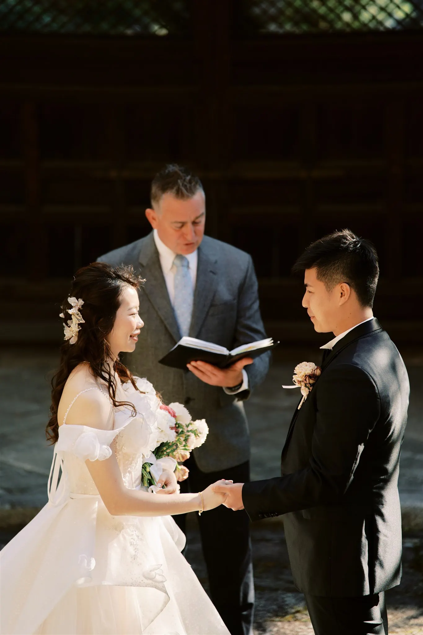 Kyoto Tokyo Japan Elopement Wedding Photographer, Planner & Videographer | A Japan elopement photographer captures the heartfelt exchange of vows between a bride and groom in an outdoor ceremony.