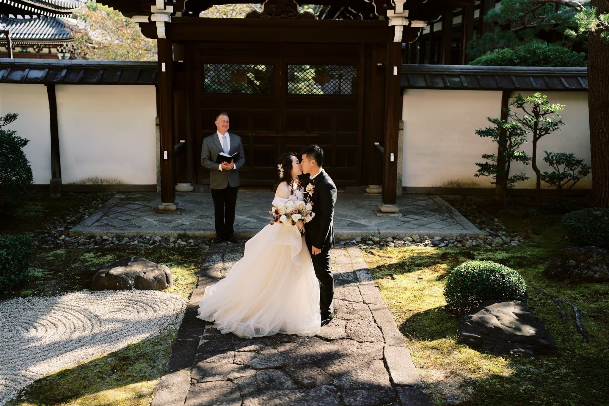 Kyoto Tokyo Japan Elopement Wedding Photographer, Planner & Videographer | A bride and groom elegantly captured by a Japan elopement photographer amidst the enchanting backdrop of a Japanese garden.