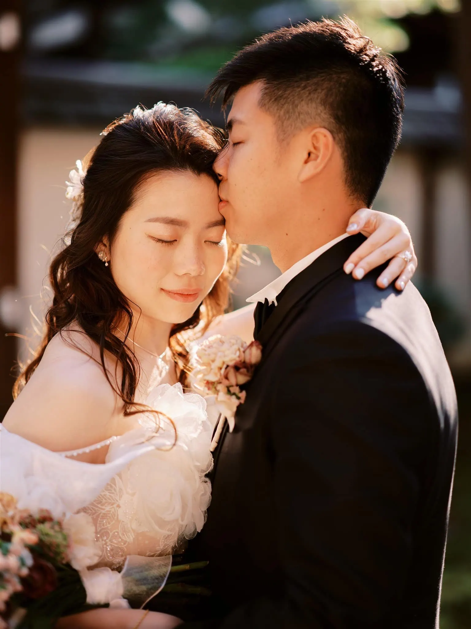 Kyoto Tokyo Japan Elopement Wedding Photographer, Planner & Videographer | An enchanting Japan elopement photographer captures a deeply intimate moment as a radiant bride and groom embrace in front of a majestic tree.