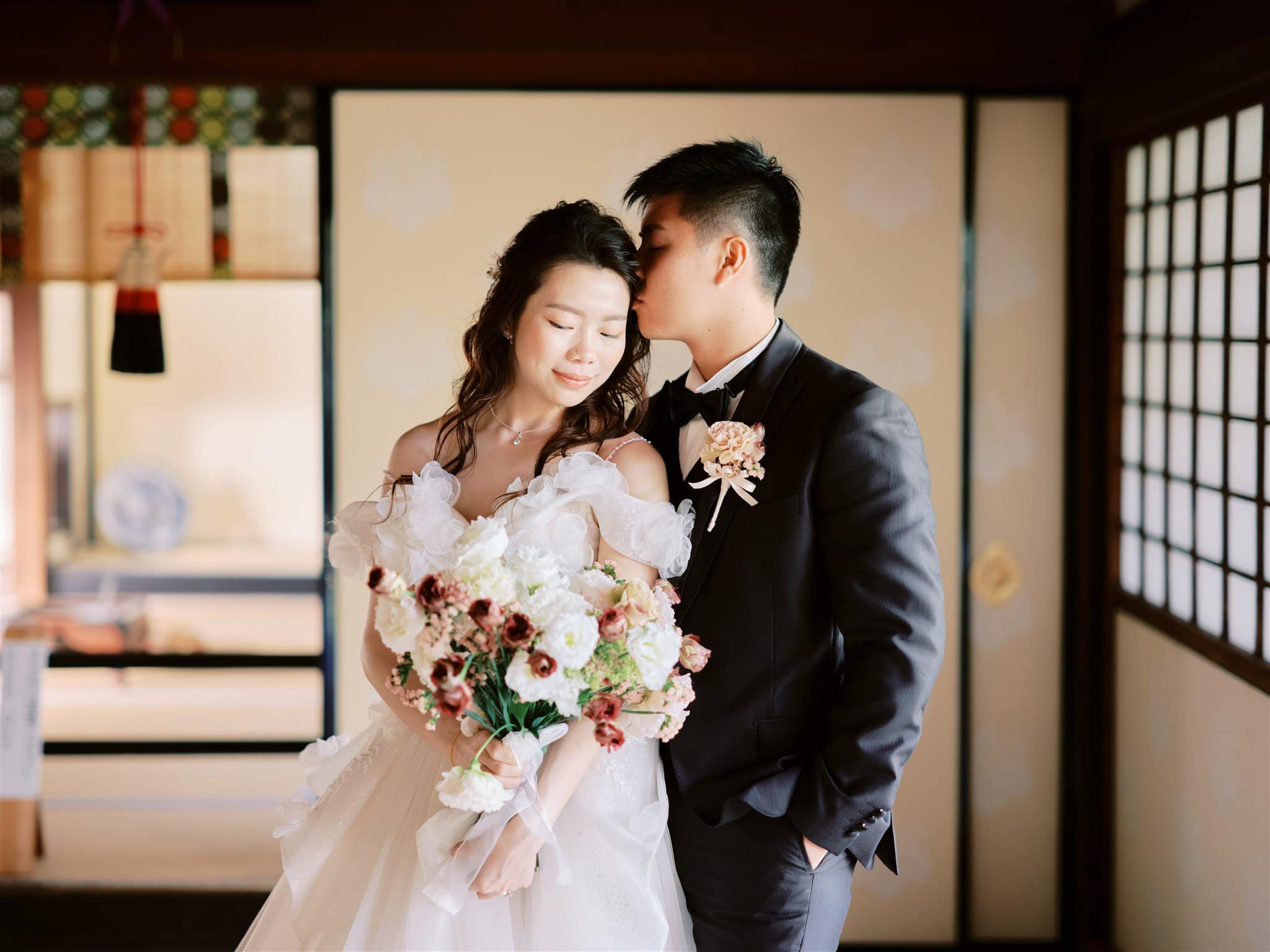 Kyoto Tokyo Japan Elopement Wedding Photographer, Planner & Videographer | A bride and groom elegantly posing in a traditional Japanese room captured by a talented Japan elopement photographer.