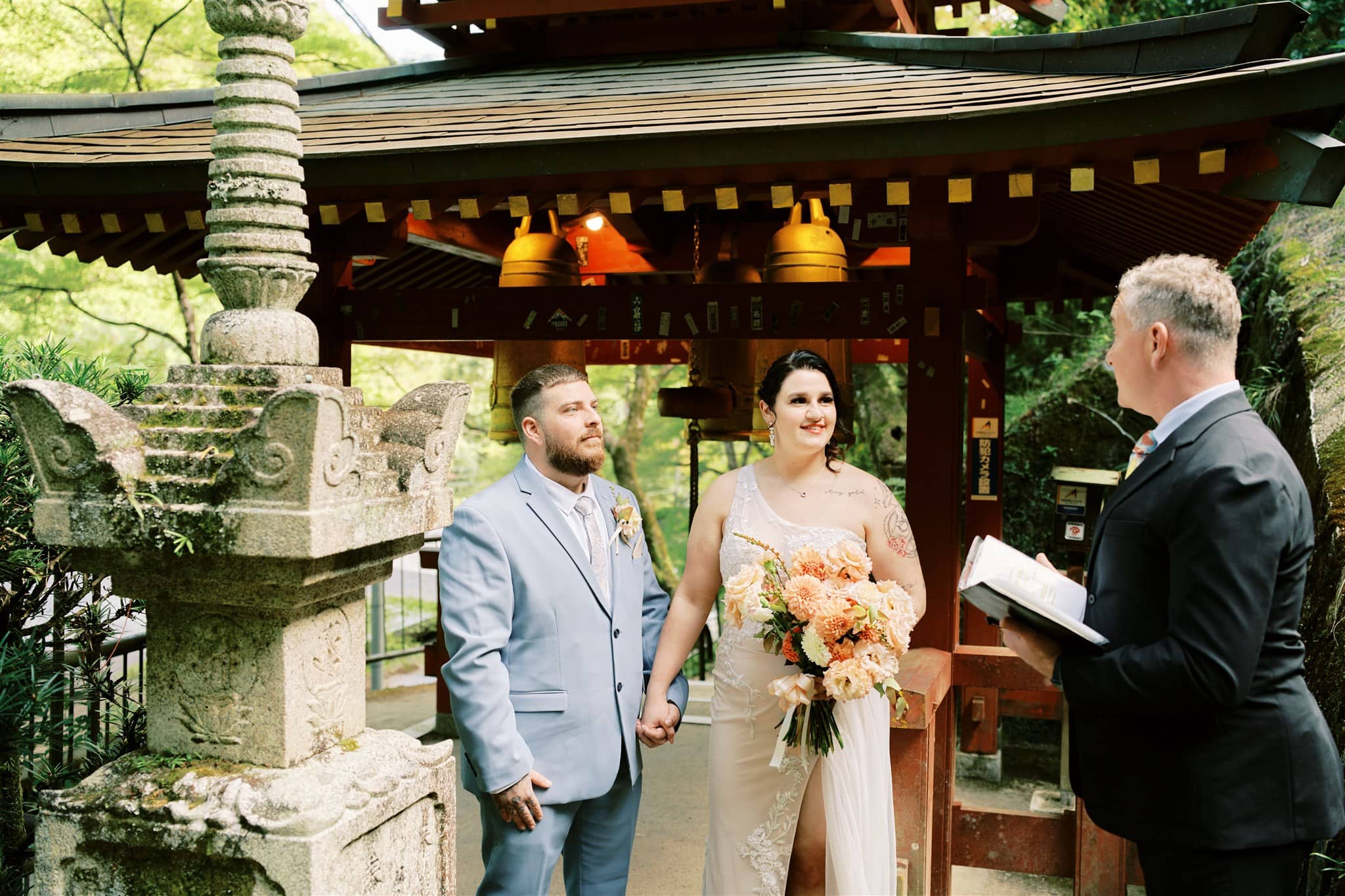 Kyoto Tokyo Japan Elopement Wedding Photographer, Planner & Videographer | A bride and groom exchange vows in front of a pagoda during their intimate Japan elopement, captured by a talented photographer.