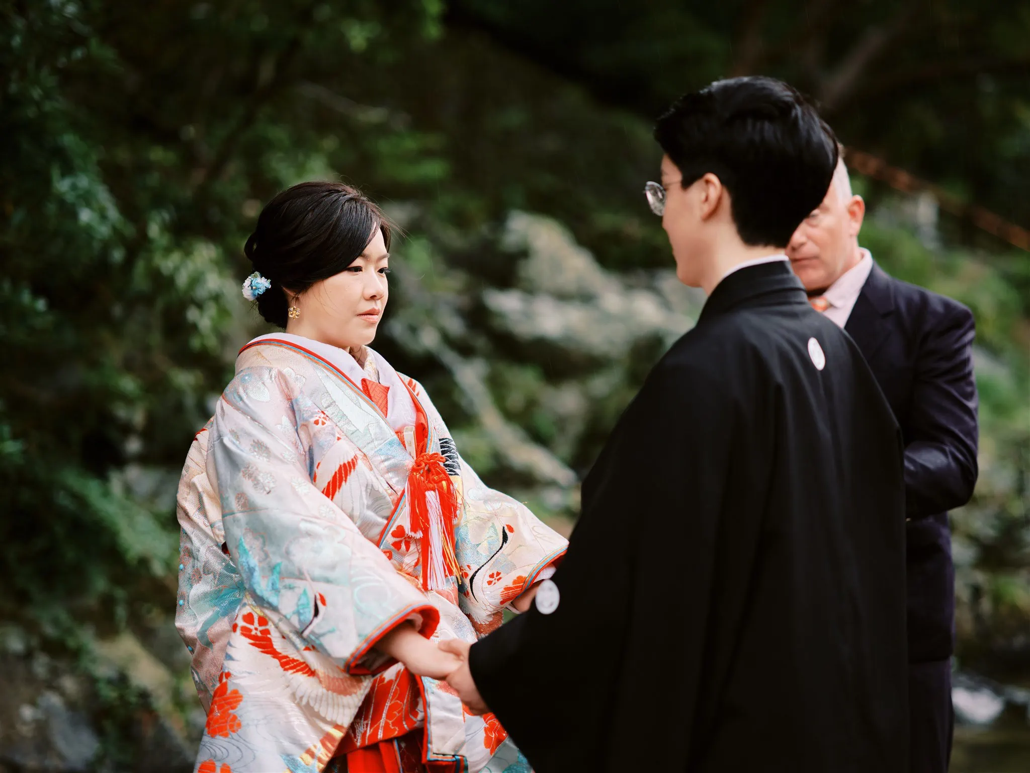 Kyoto Tokyo Japan Elopement Wedding Photographer, Planner & Videographer | A man and woman in kimono standing next to a river captured by an elopement photographer.
