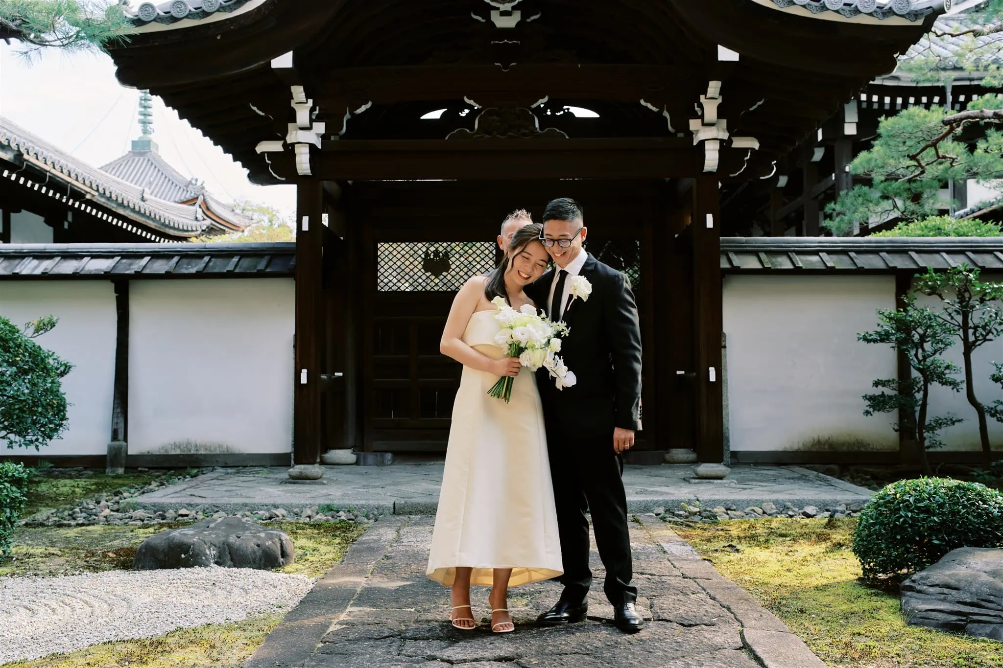 Kyoto Tokyo Japan Elopement Wedding Photographer, Planner & Videographer | A Japan elopement with a couple standing in front of a Japanese temple.