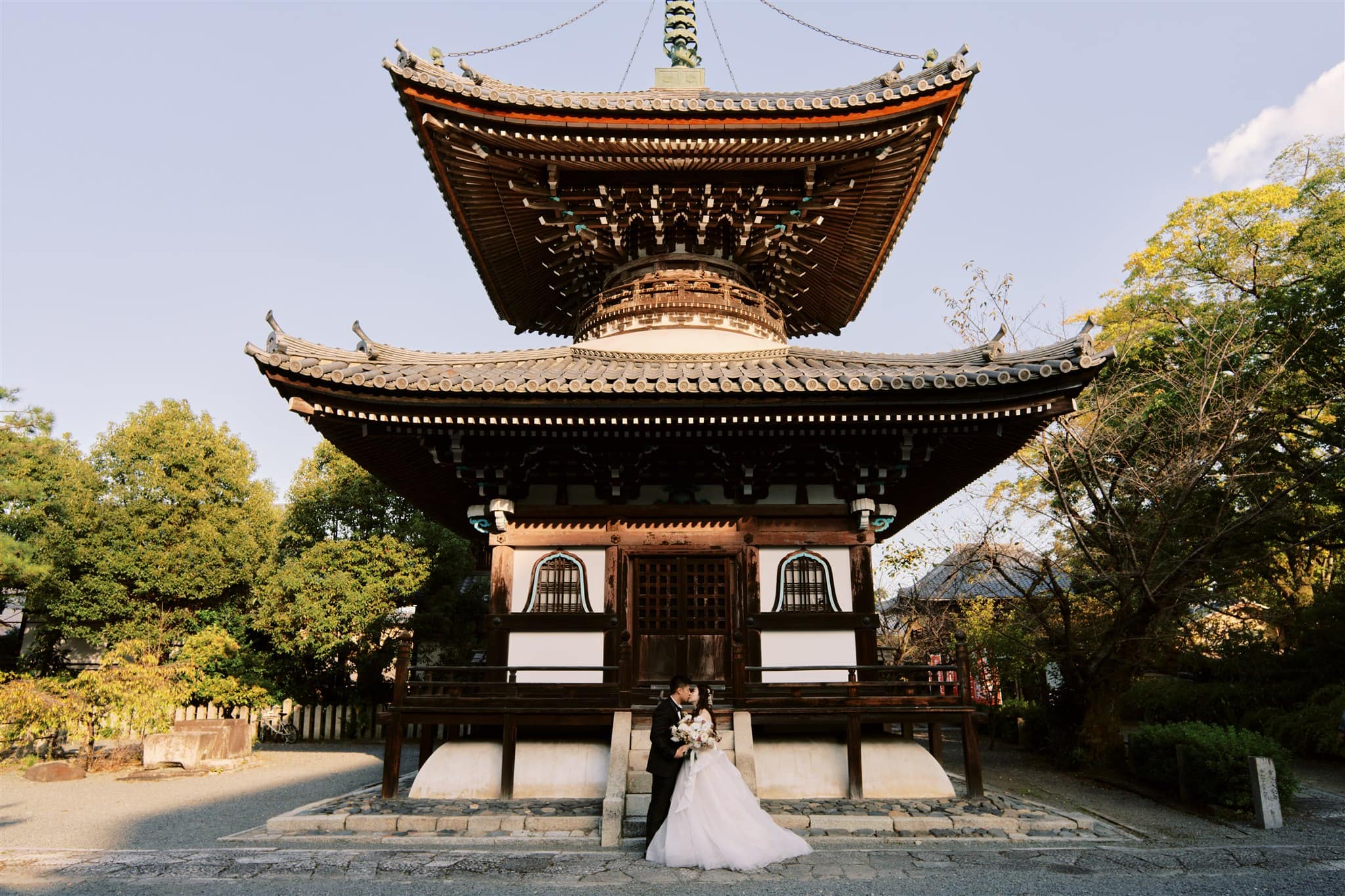 Kyoto Tokyo Japan Elopement Wedding Photographer, Planner & Videographer | A Japan elopement photographer captures a bride and groom posing in front of a pagoda.