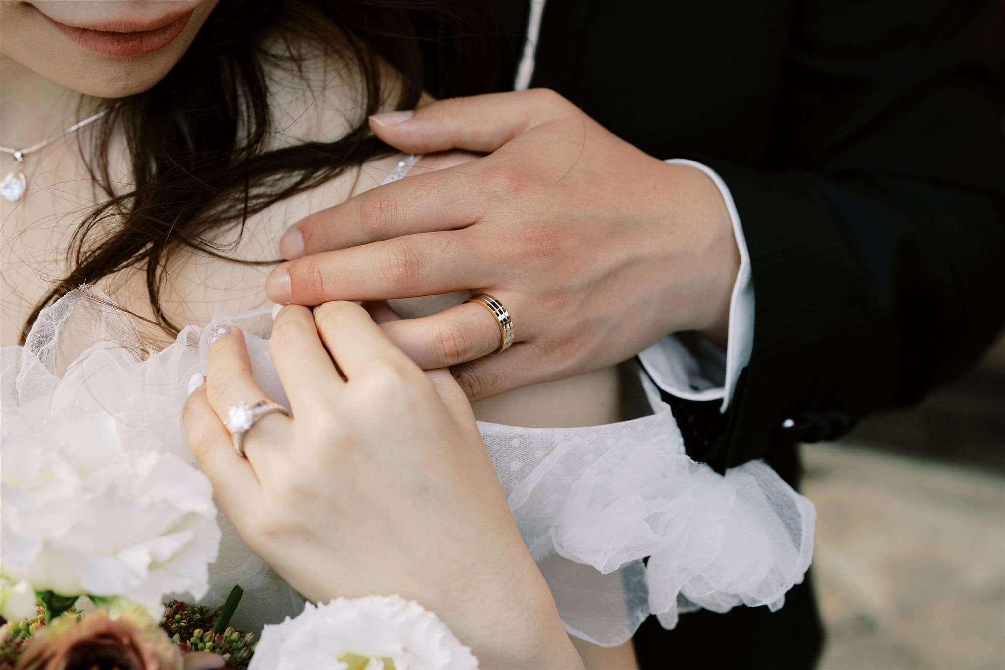 Kyoto Tokyo Japan Elopement Wedding Photographer, Planner & Videographer | A Japan elopement photographer captures stunning images of a bride and groom showcasing their wedding rings on their hands.