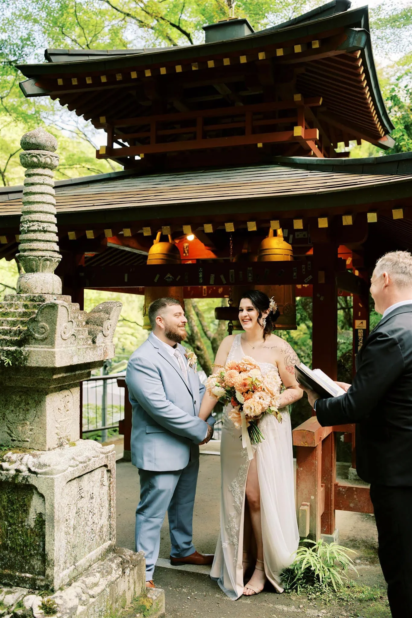 Kyoto Tokyo Japan Elopement Wedding Photographer, Planner & Videographer | A photographer captures a bride and groom's Japan elopement ceremony in front of a Japanese pagoda.