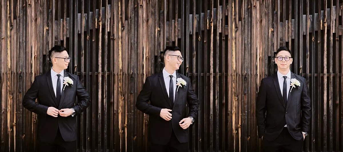 Kyoto Tokyo Japan Elopement Wedding Photographer, Planner & Videographer | A man in a suit is standing in front of a wooden wall in Japan.