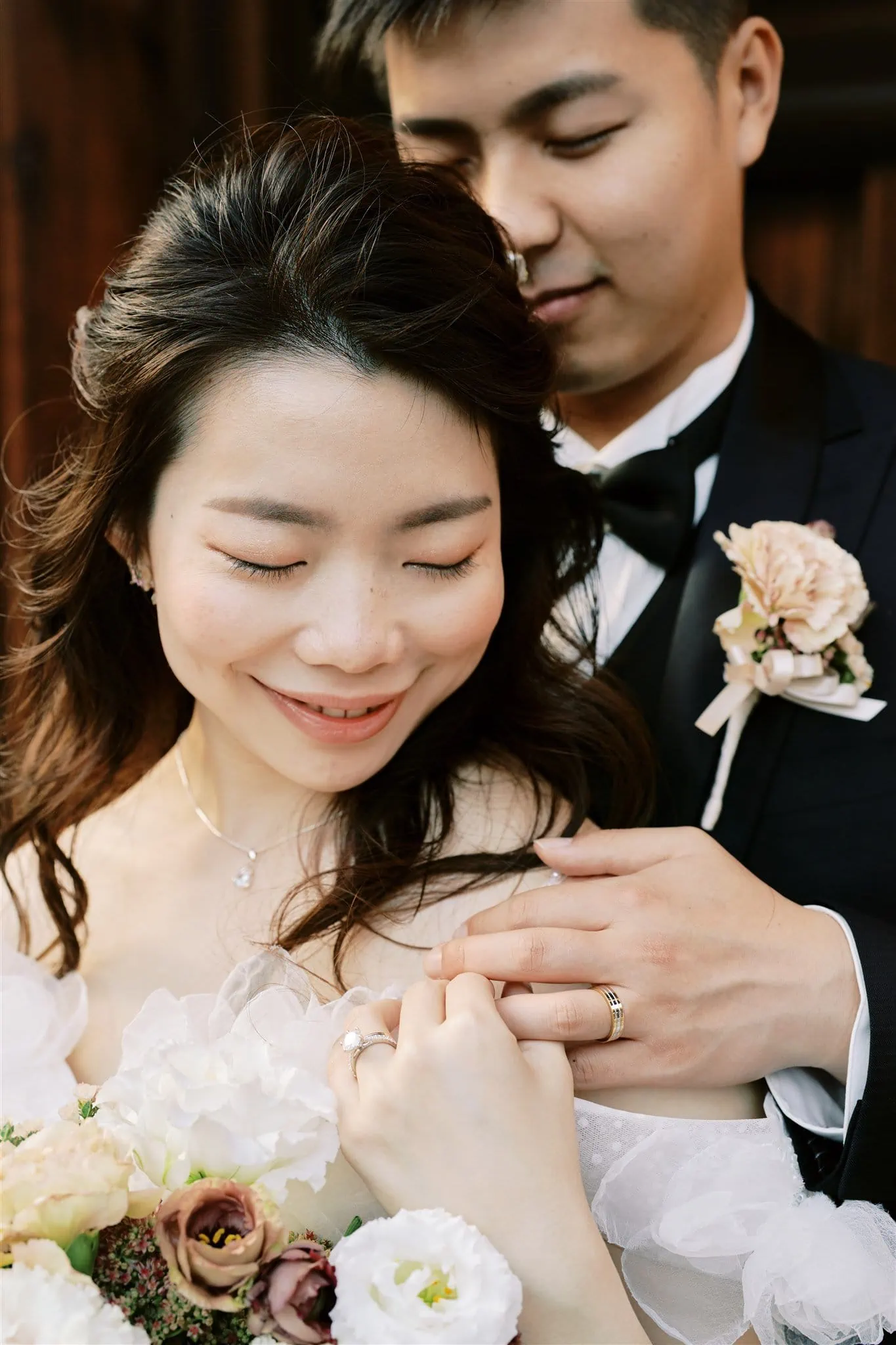 Kyoto Tokyo Japan Elopement Wedding Photographer, Planner & Videographer | A Japan elopement photographer captures an intimate moment as a bride and groom embrace each other in front of a stunning building.