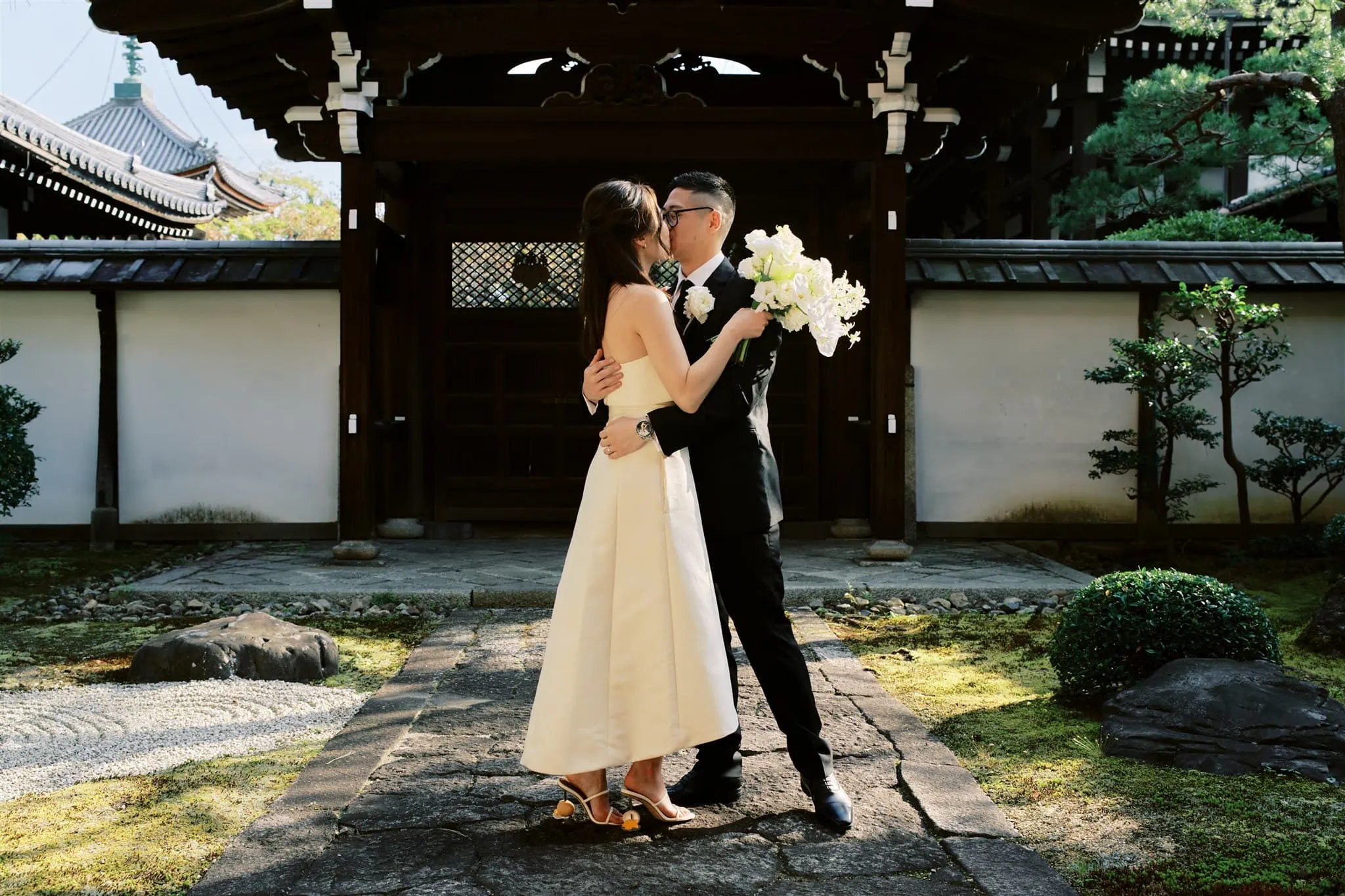 Kyoto Tokyo Japan Elopement Wedding Photographer, Planner & Videographer | A blissful bride and groom embracing in front of a stunning Japanese pagoda, capturing the essence of their intimate elopement in Japan.