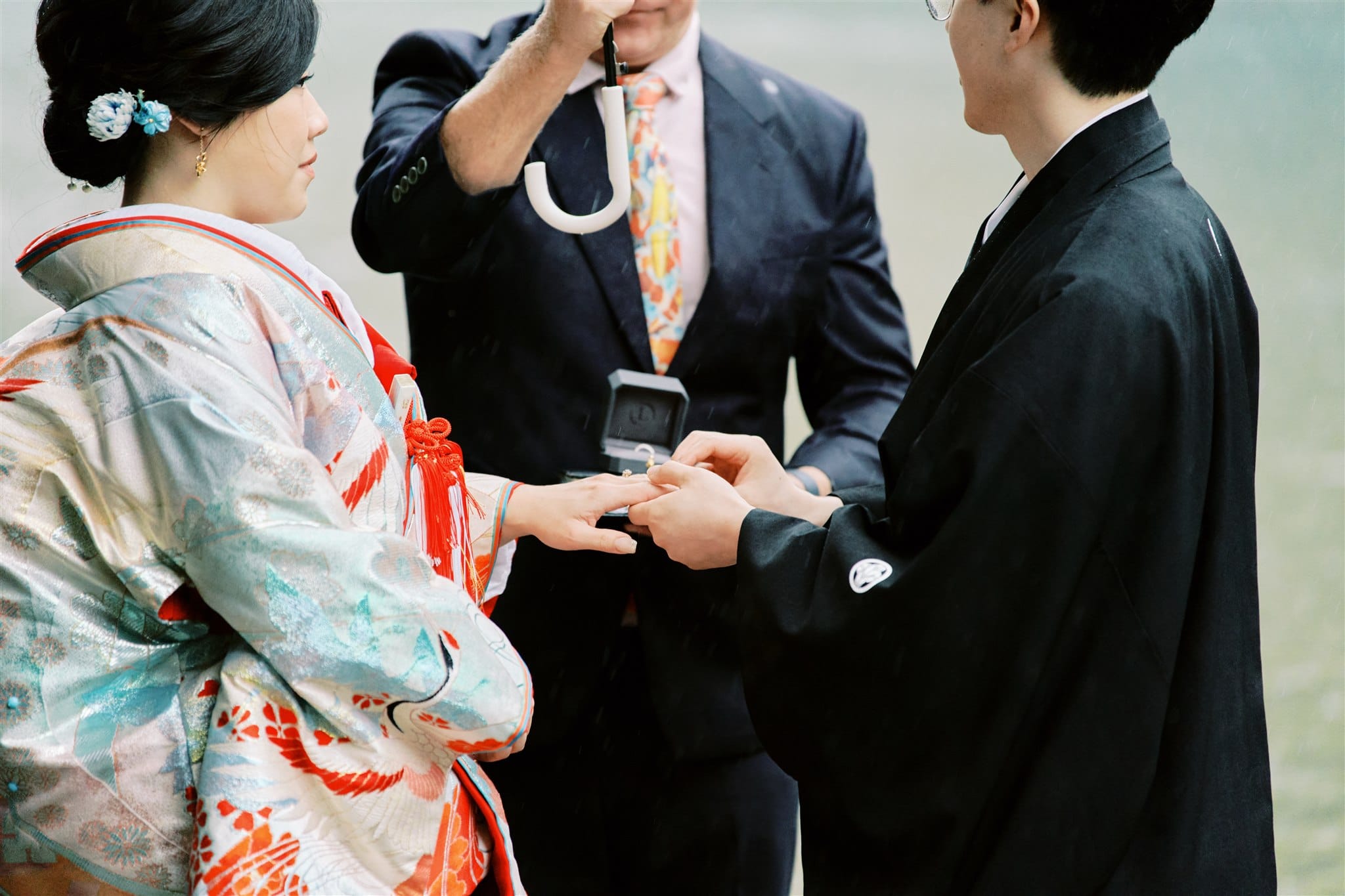 Kyoto Tokyo Japan Elopement Wedding Photographer, Planner & Videographer | An elopement photographer captures the moment a man delicately places a ring on a woman's finger.