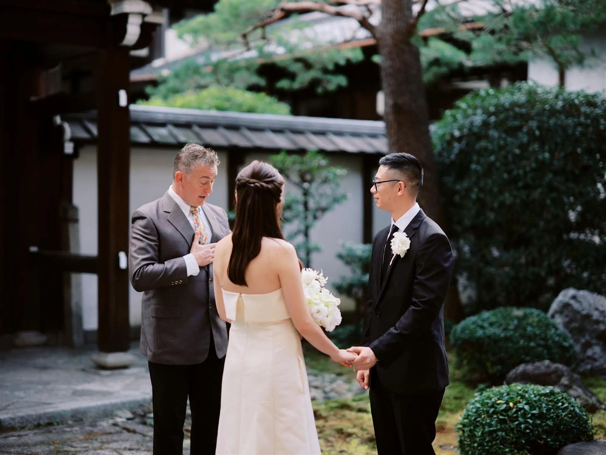 Kyoto Tokyo Japan Elopement Wedding Photographer, Planner & Videographer | A bride and groom exchange vows in a Japanese garden during their Japan elopement.