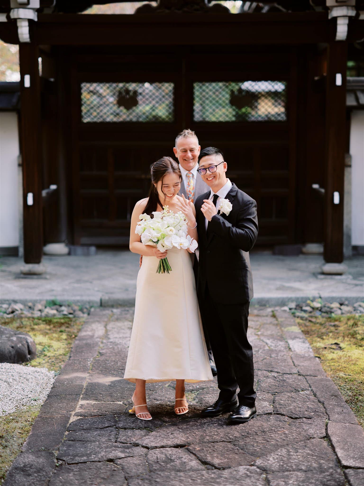 Kyoto Tokyo Japan Elopement Wedding Photographer, Planner & Videographer | A Japan elopement takes place with a bride and groom standing in front of a Japanese temple.