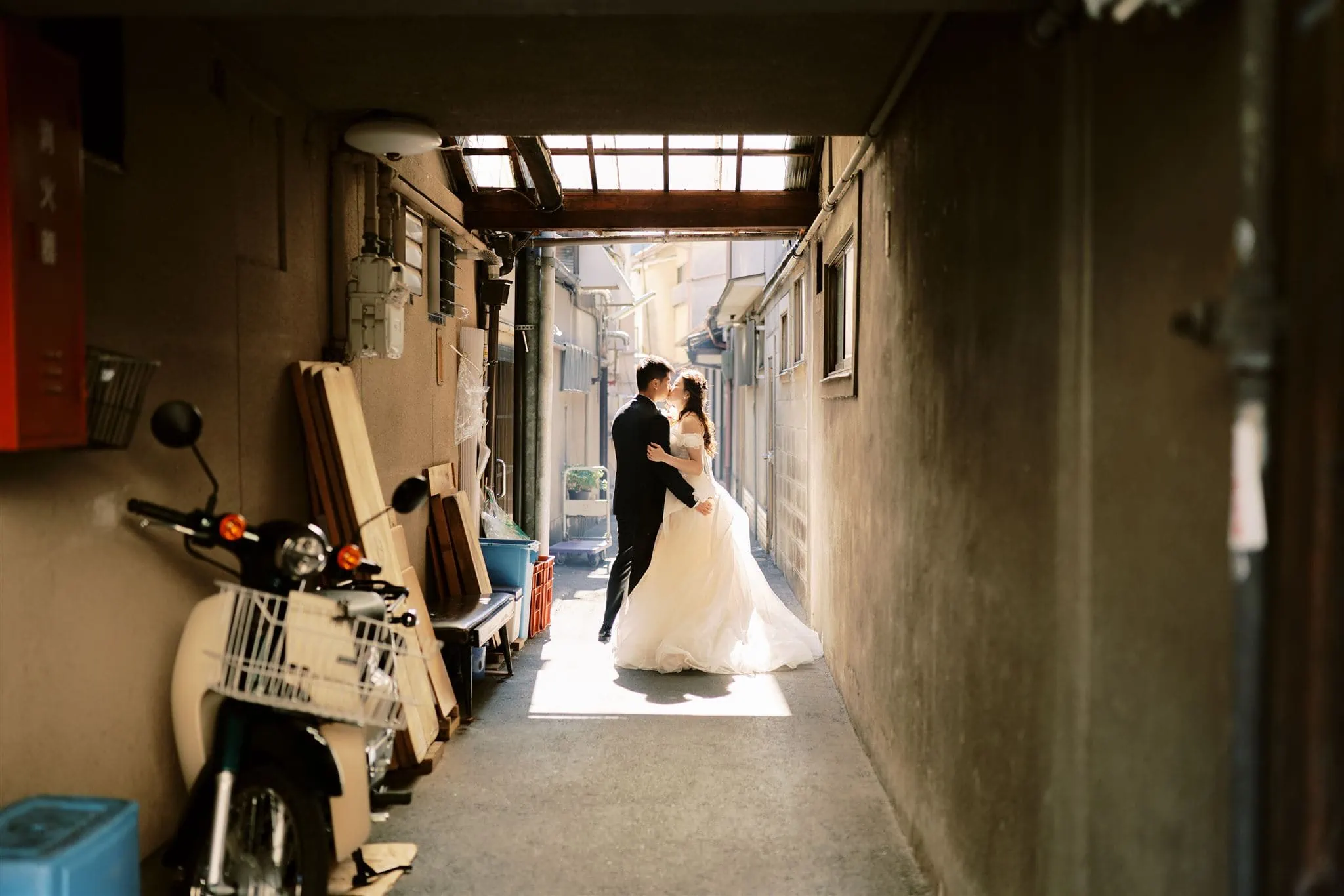 Japan Elopement Wedding Photographer, Planner & Videographer |         Description: A bride and groom experiencing a picturesque Kyoto Elopement Wedding in a narrow alleyway.