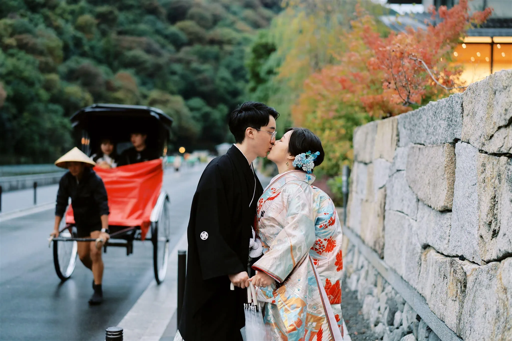 Japan Elopement Wedding Photographer, Planner & Videographer | A Japanese couple embracing in front of a carriage during their Kyoto Japan Wedding & Elopement Package.