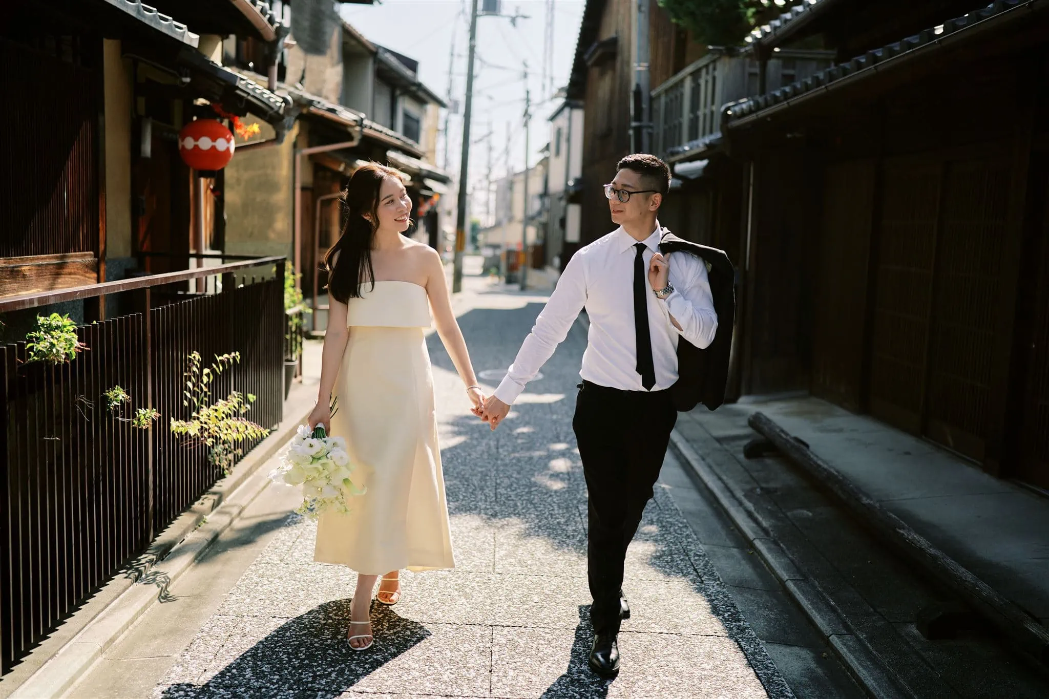 Japan Elopement Wedding Photographer, Planner & Videographer | A bride and groom enjoying their Kyoto Japan Elopement Package as they blissfully walk down a narrow alleyway.