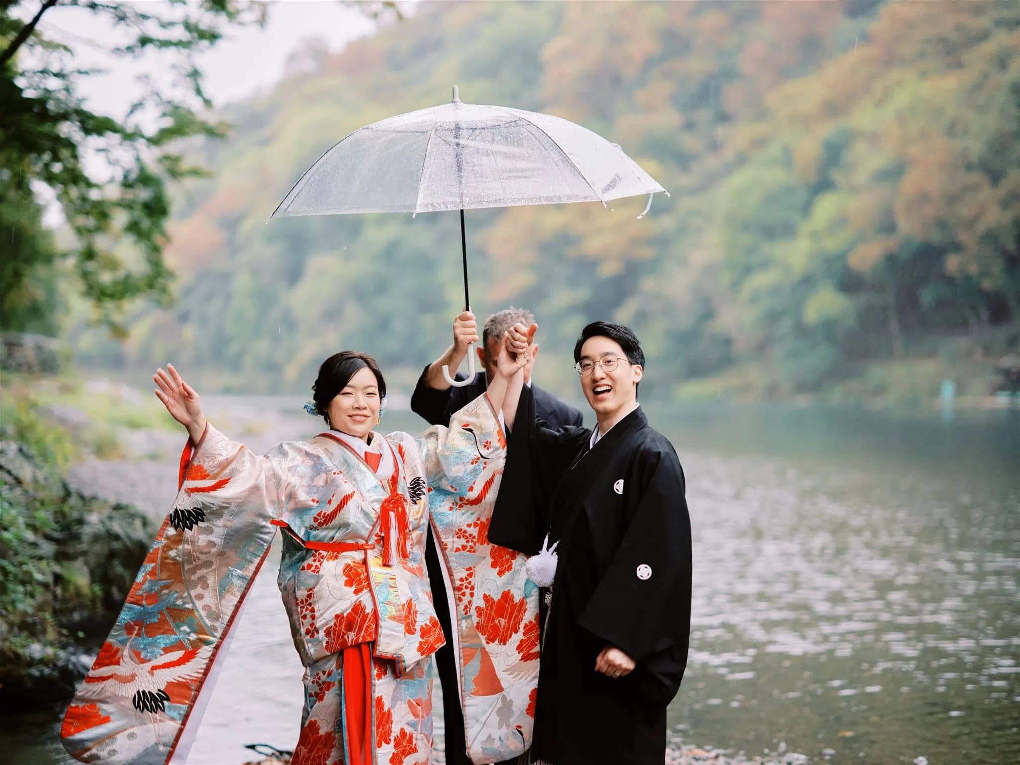Kyoto Tokyo Japan Elopement Wedding Photographer, Planner & Videographer | A group of traditional Japanese kimono clad individuals elegantly holding umbrellas, captured by a skilled elopement photographer.