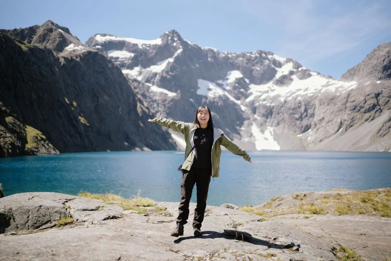woman enjoying scenic mountain lake view